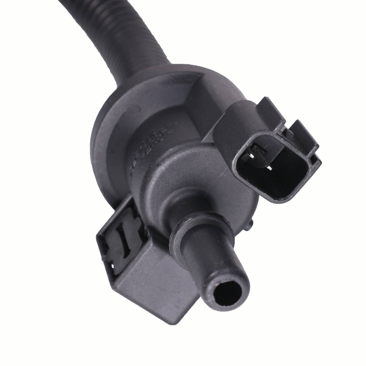 Close-up of purge solenoid housing with electrical connector and fuel port
