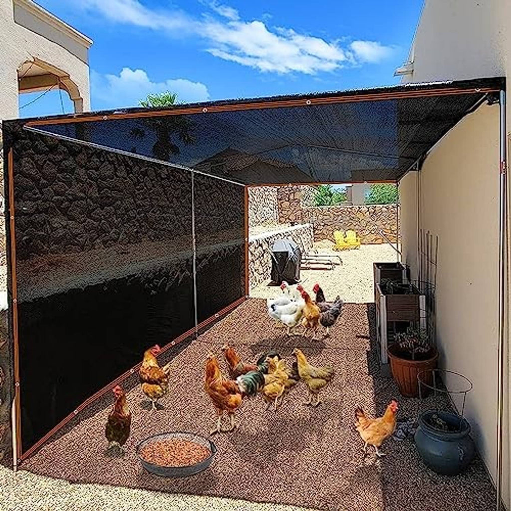 Dark mesh shade tarp canopy over yard area with brown trim and top grommets