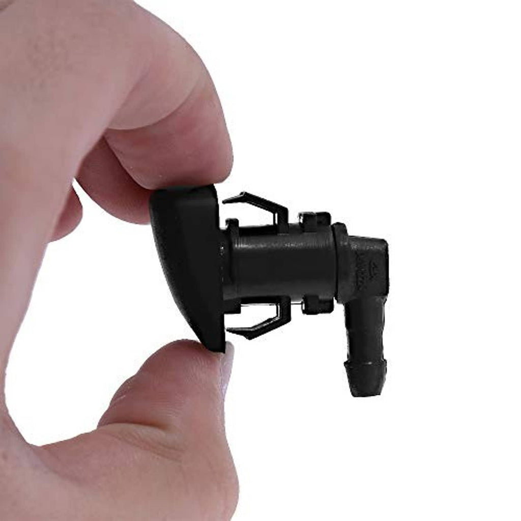 Black windshield washer nozzle held by hand, with mounting clip and outlet