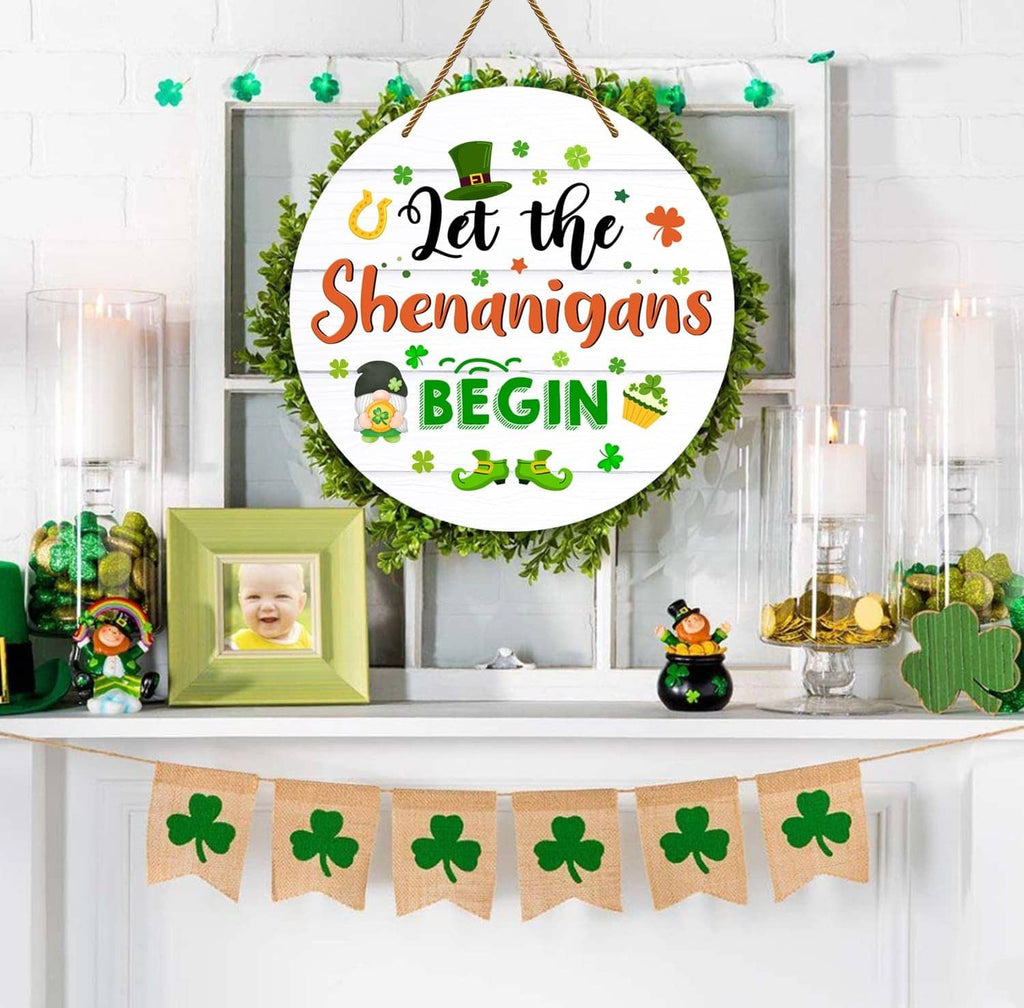 Round hanging door sign displayed above decor, “Let the Shenanigans Begin”