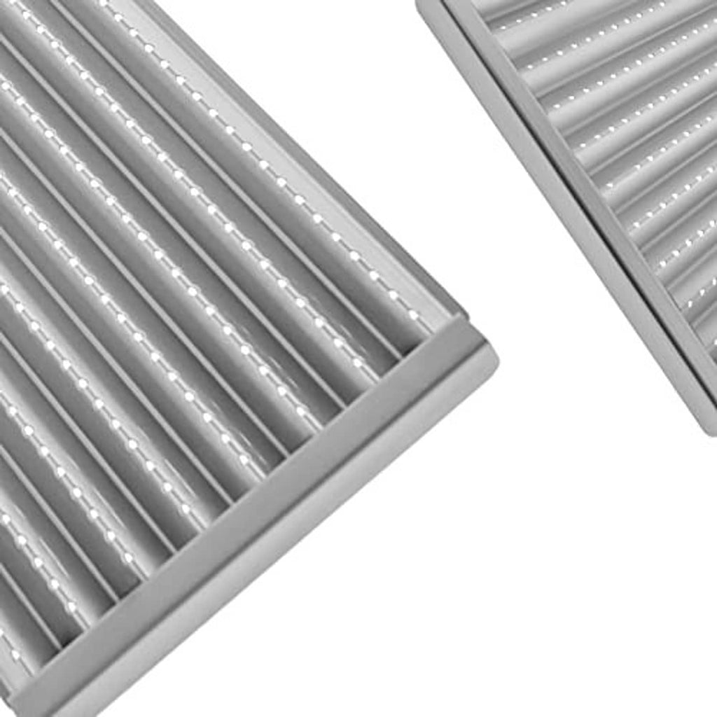 Close-up of stainless steel grill grate bars with parallel ridges