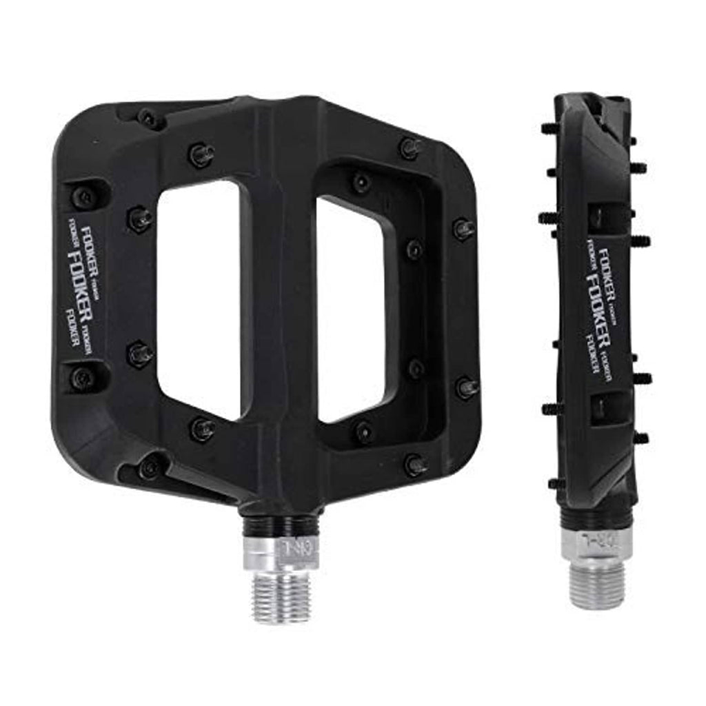 Black MTB flat pedals with open grip platforms and threaded axles, close-up