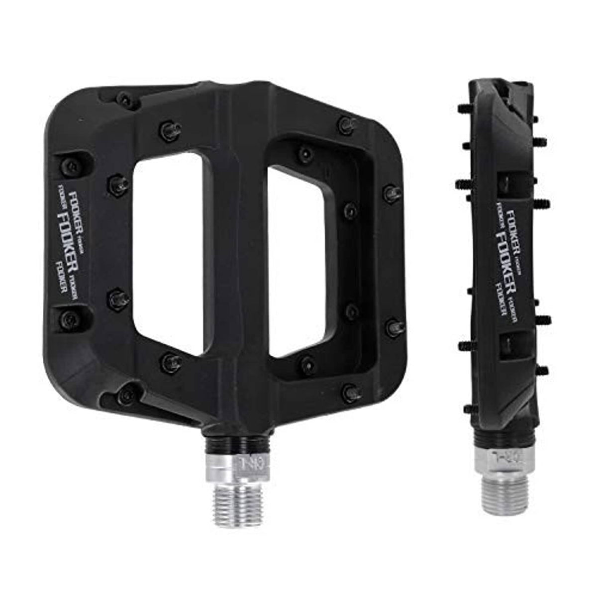 Black MTB flat pedals with open grip platforms and threaded axles, close-up