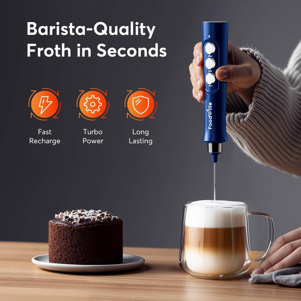 Blue handheld milk frother releasing foam into a clear mug.