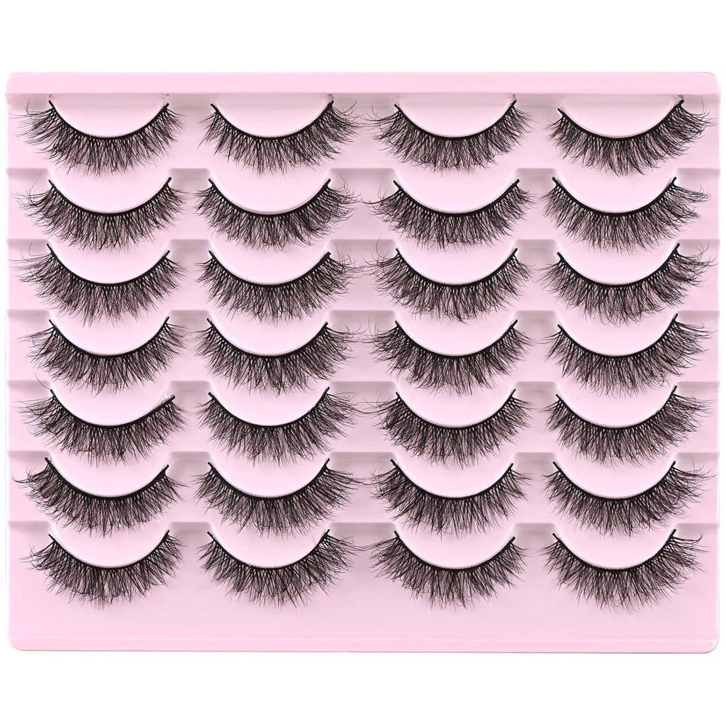 Multiple pairs of natural short wispy false mink lashes arranged on pink tray