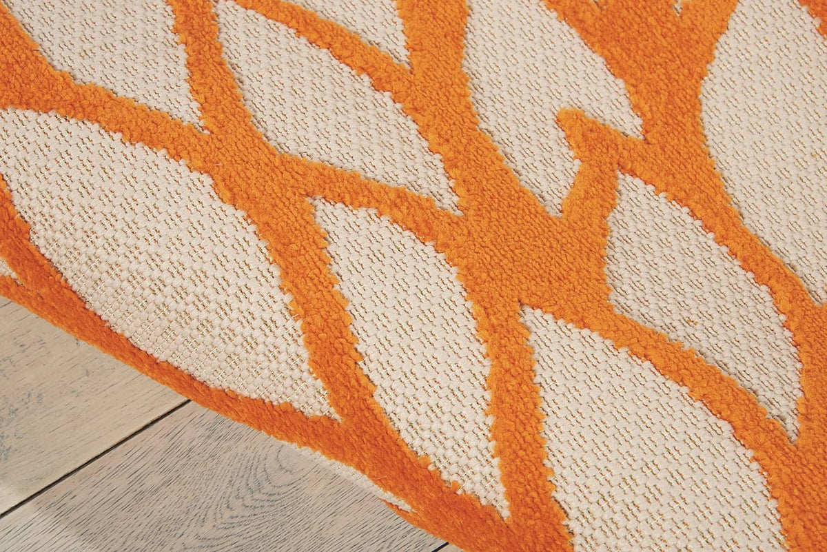 Tropical area rug close-up of orange and off-white fan pattern with textured weave