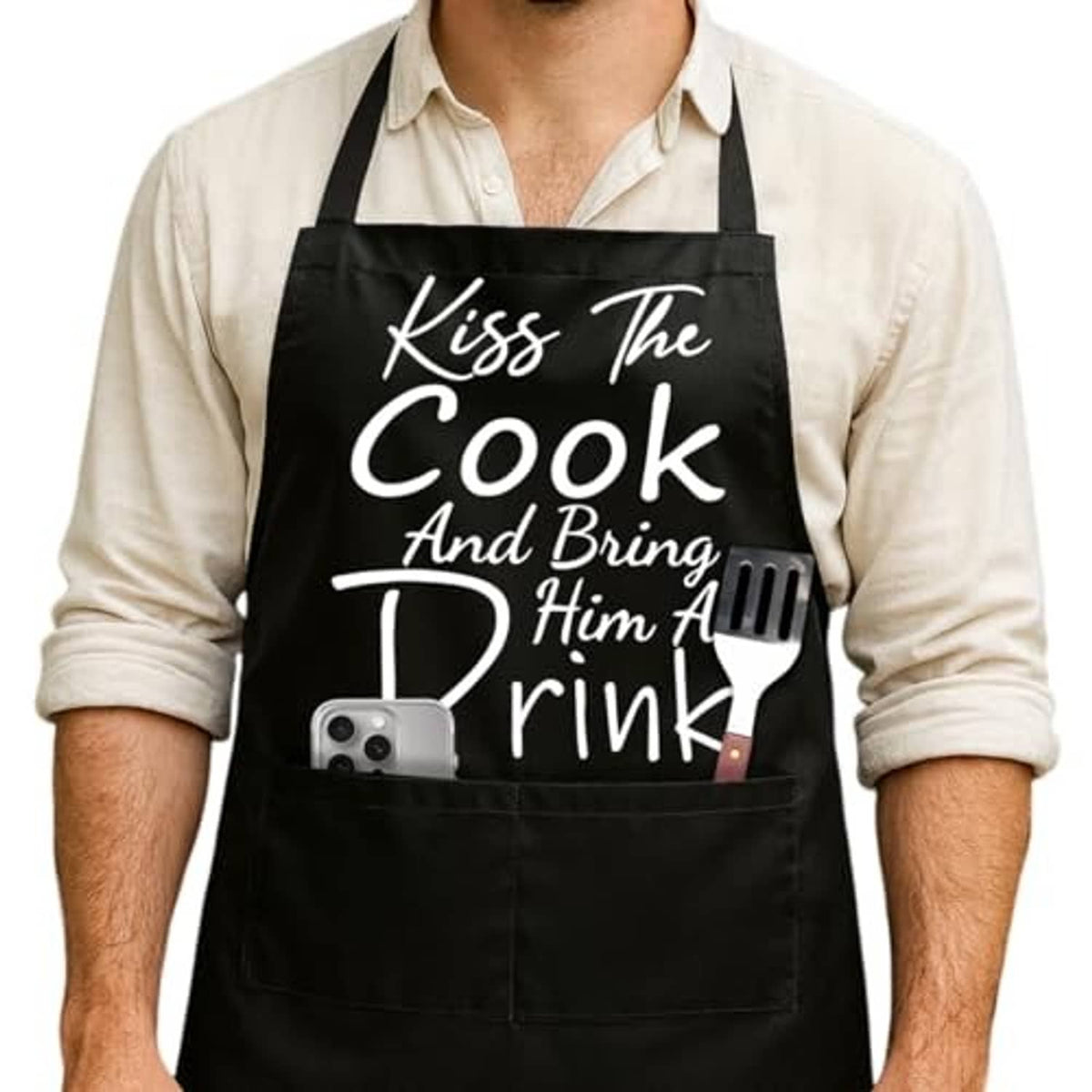 Black adjustable cooking apron with “Kiss The Cook” slogan and grill fork design