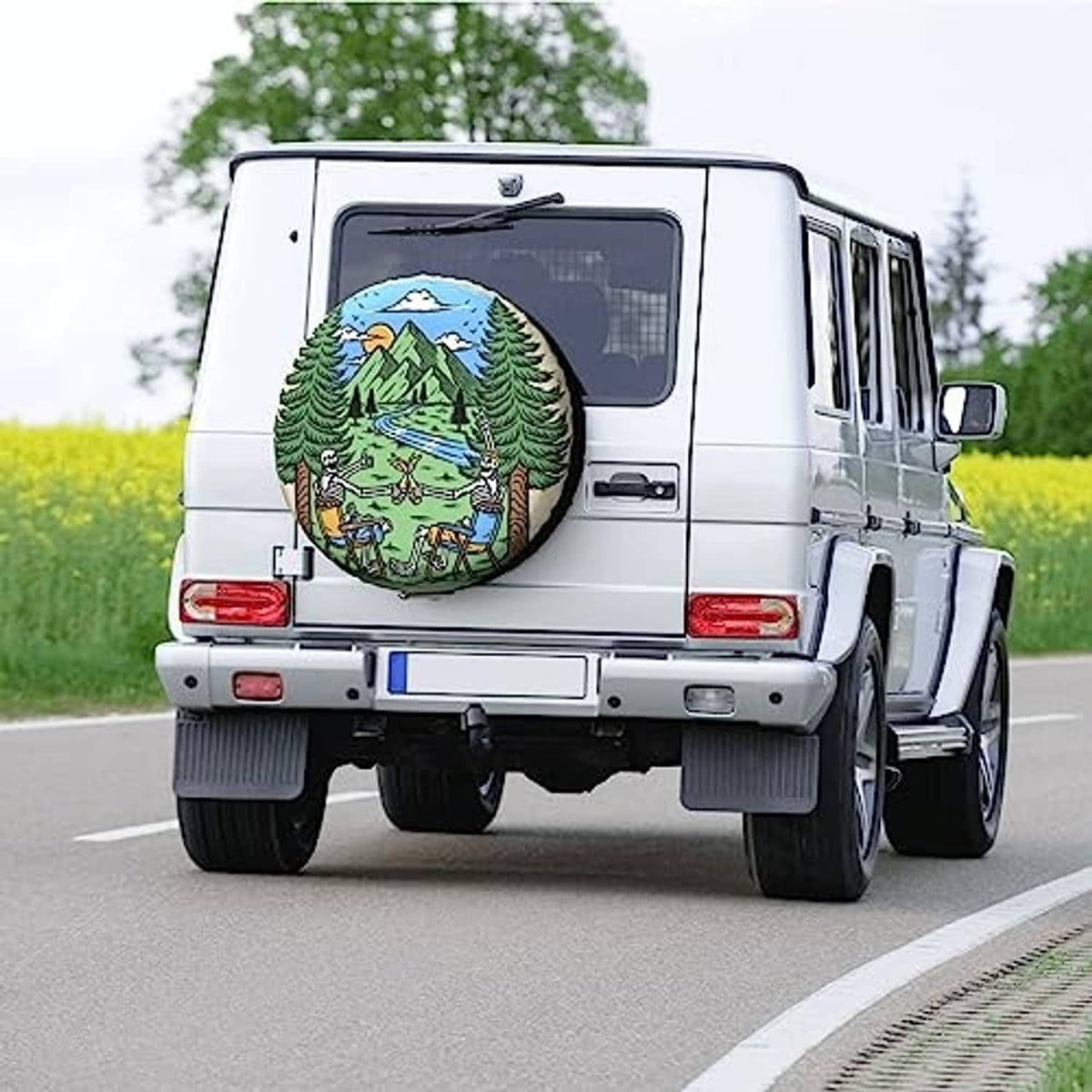 Spare tire cover on rear of white van, featuring a colorful forest camping landscape graphic