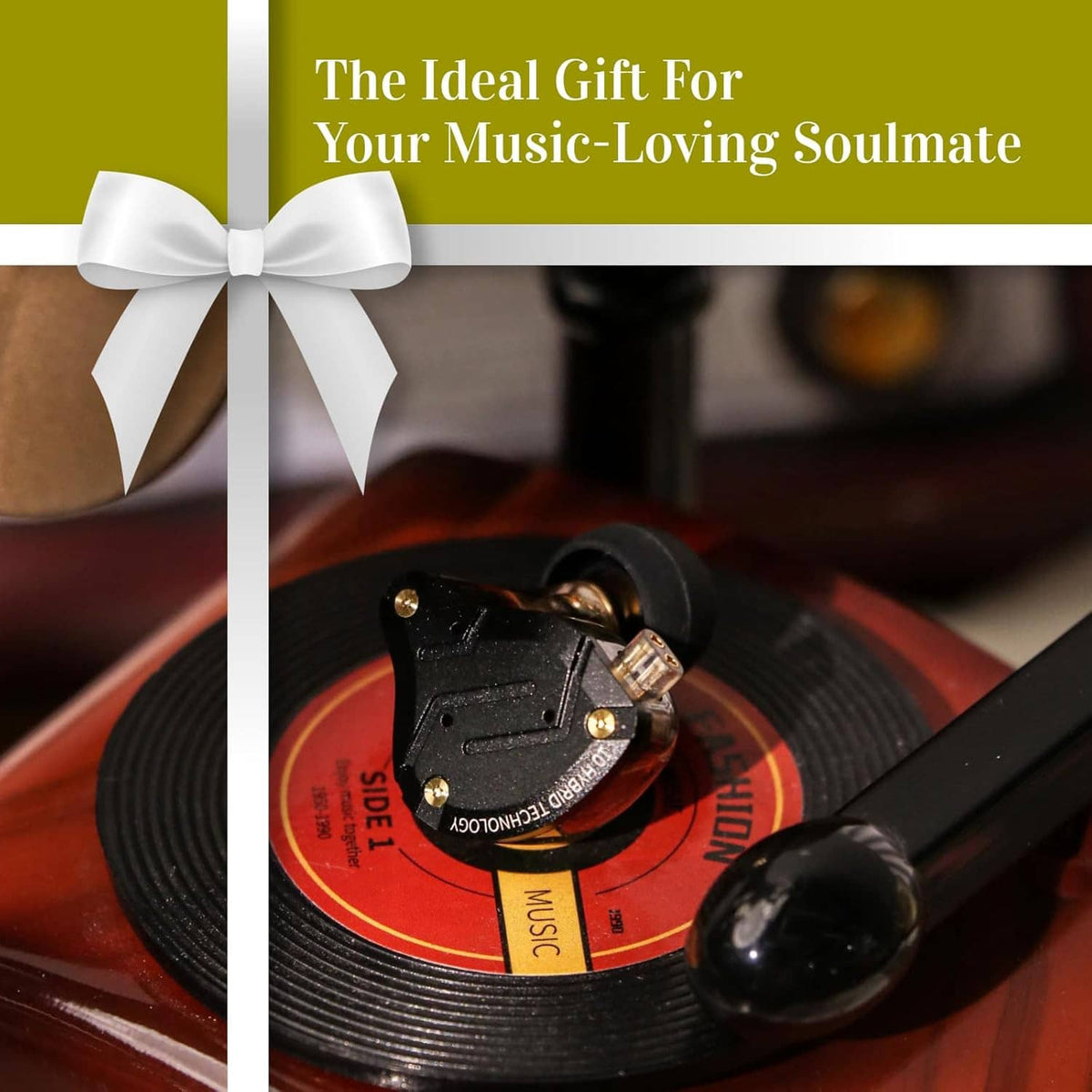 In-ear monitors with black eartips placed on a vinyl record with a gift ribbon