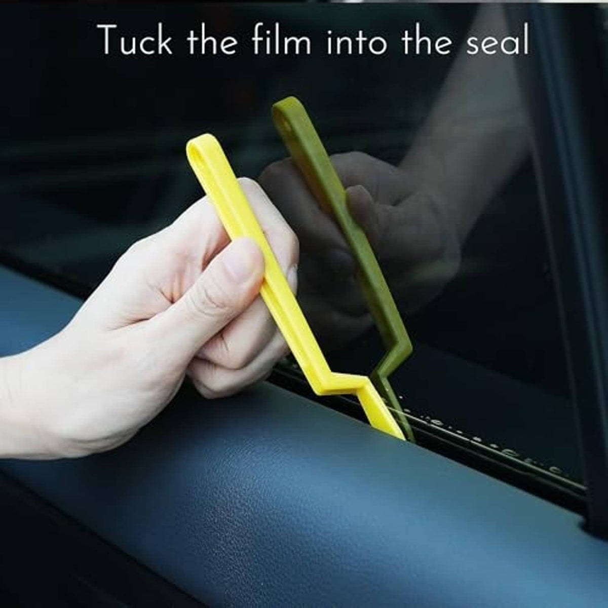 Yellow film tuck tool used to tuck window film into the door seal gap.