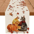 Fall table runner with tabby cat, pumpkins, and maple leaves on white fabric