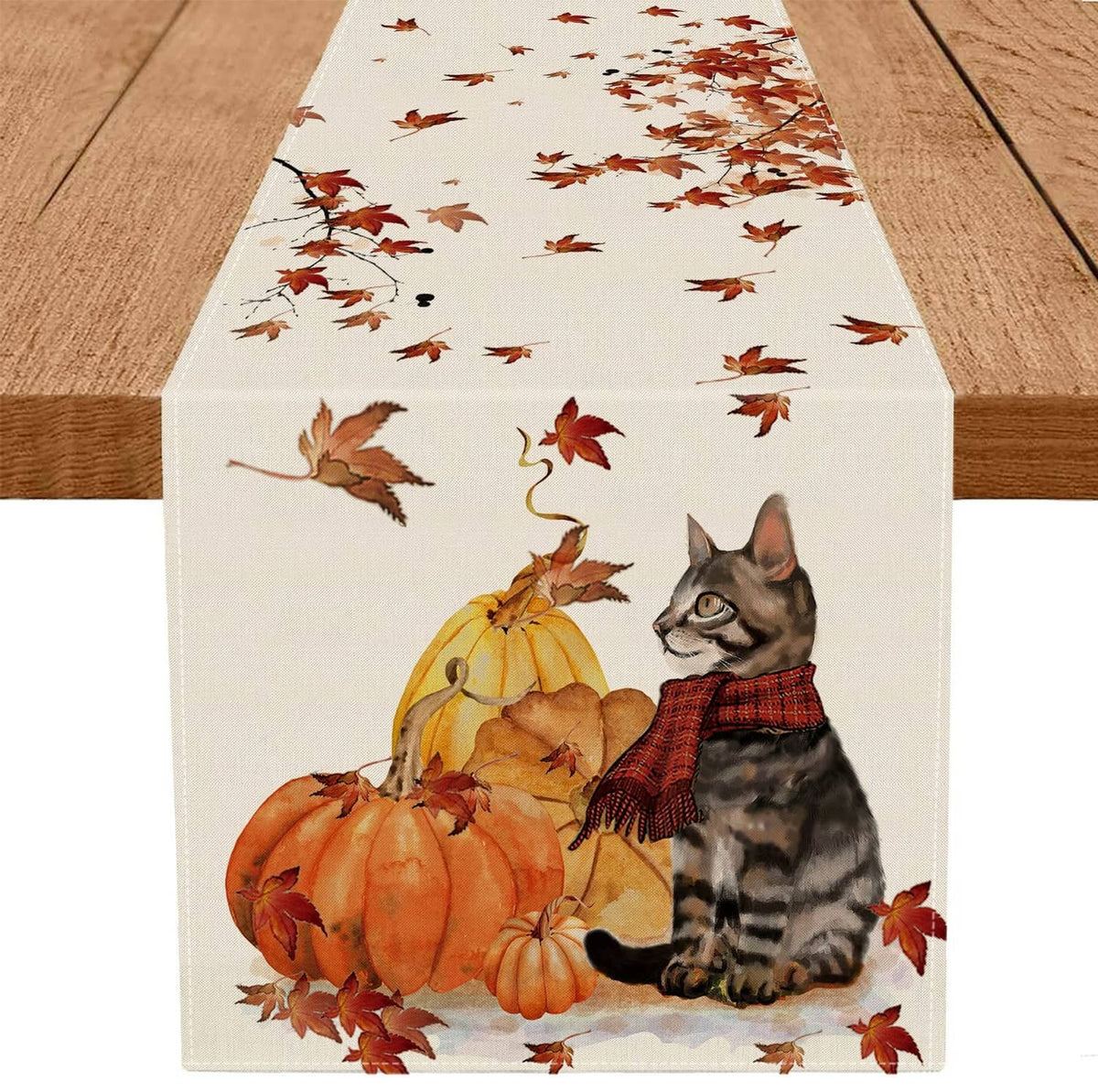 Fall table runner with tabby cat, pumpkins, and maple leaves on white fabric