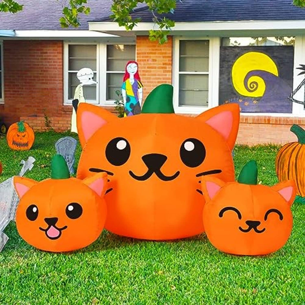 Orange inflatable cat-head trio with green cone hats, outdoor lawn Halloween decoration