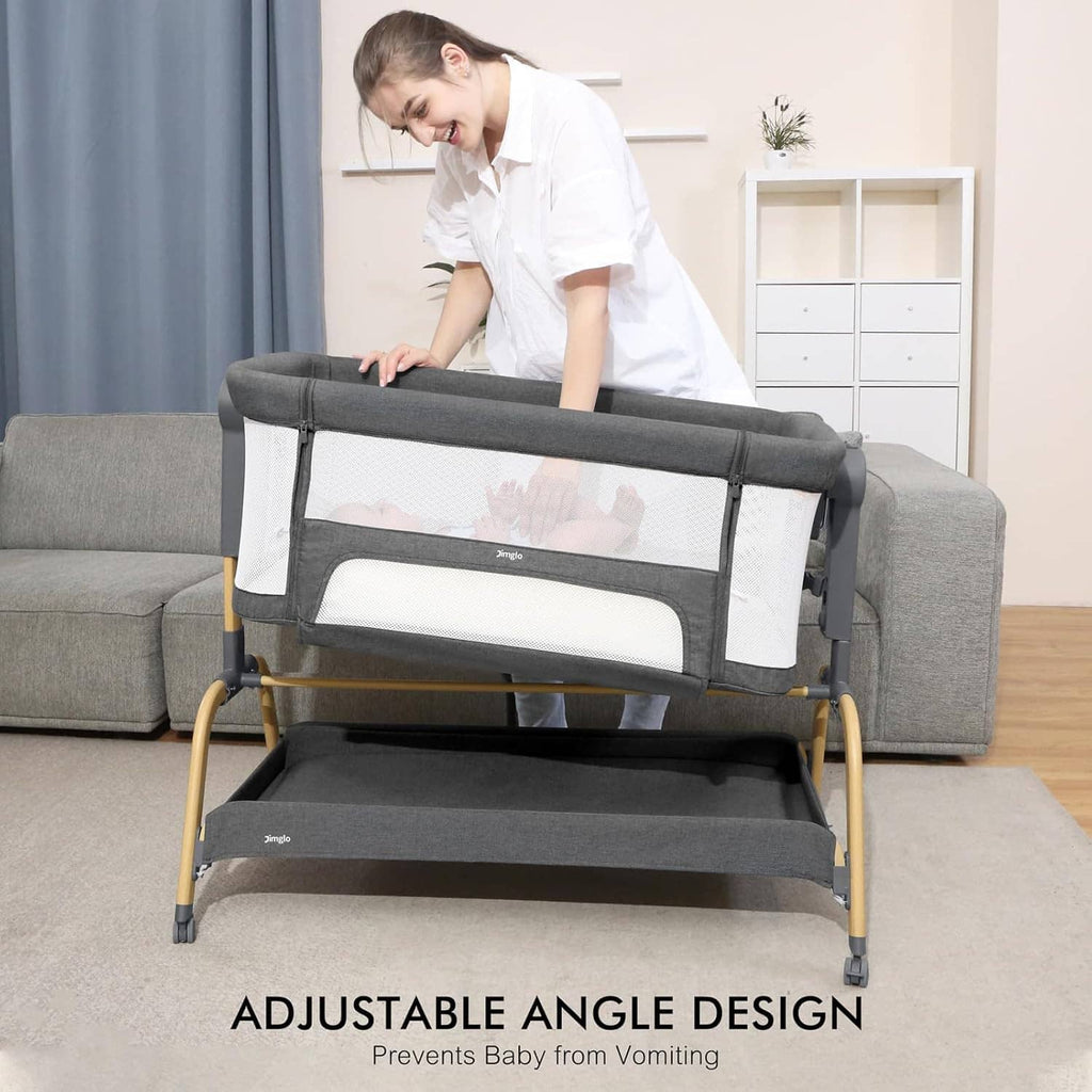 Gray bedside baby bassinet with adjustable angle rail and white mesh side panels.