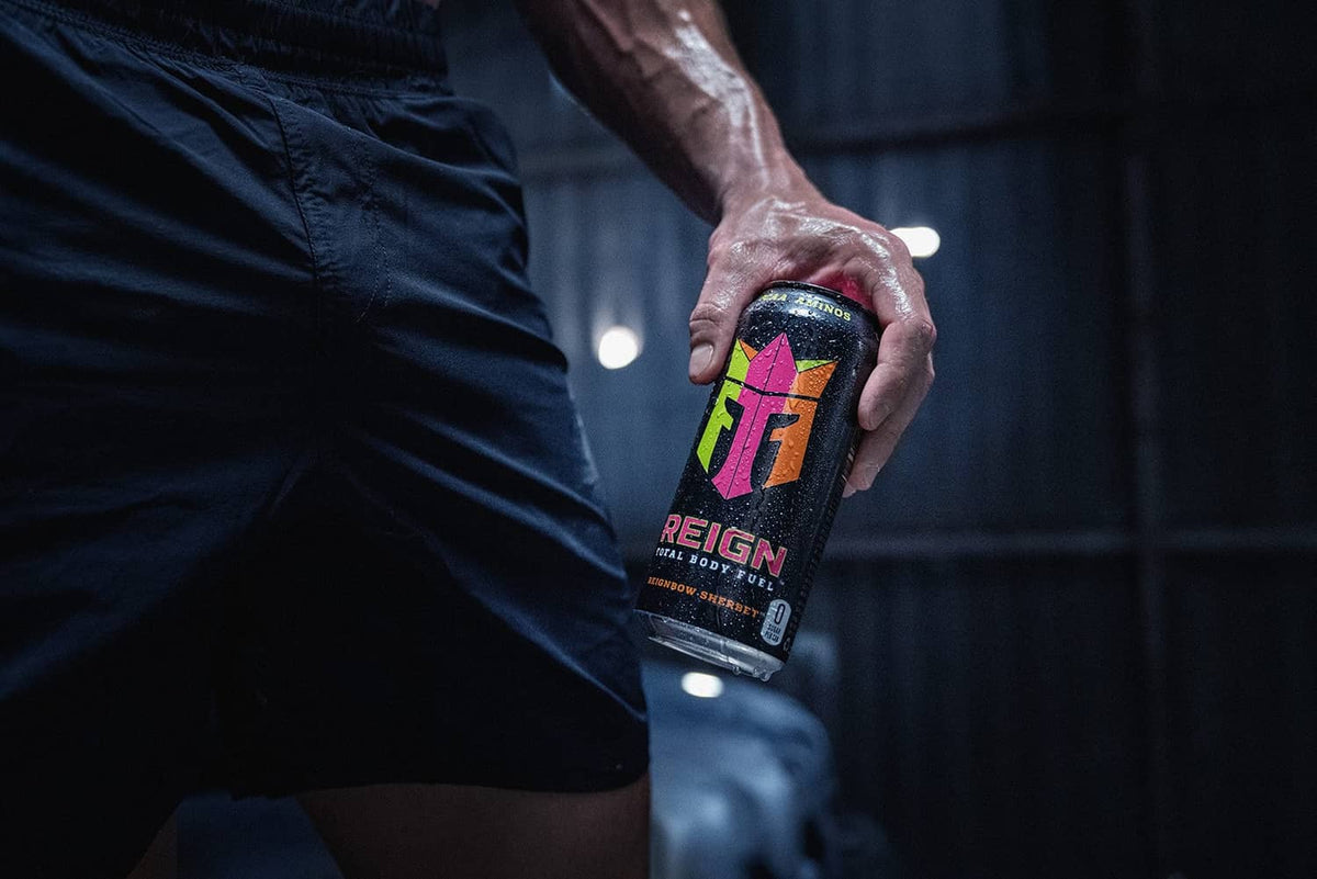 Reign fitness drink can (Reignbow Sherbet) in athlete's hand
