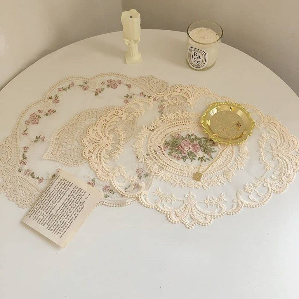 Beige crochet lace placemat featuring an oval floral medallion and filigree border