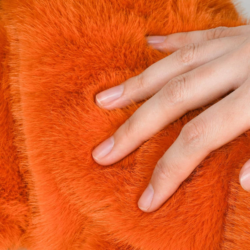 Close-up of orange plush fabric on the driver headcover with stitched seam