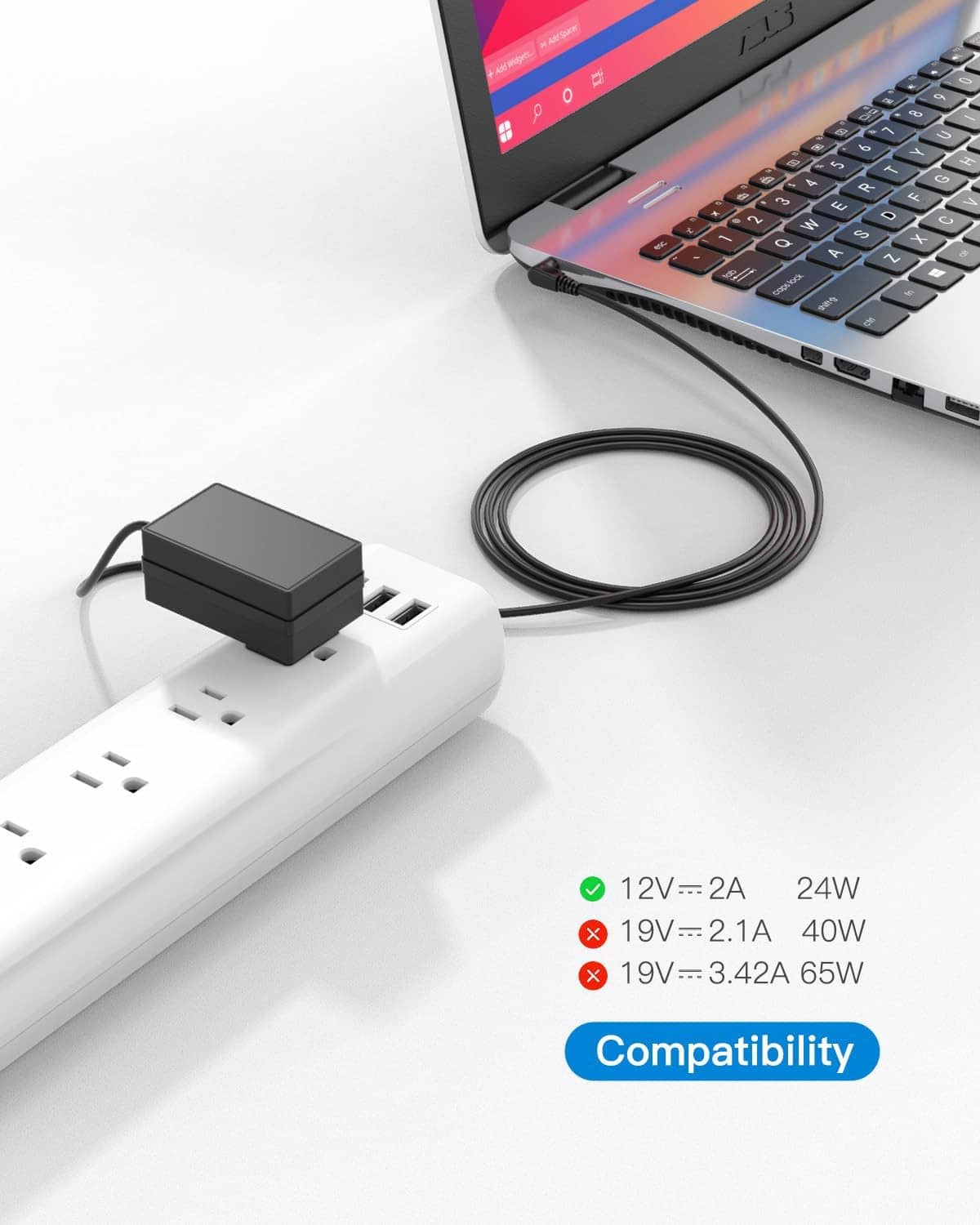 12V laptop power charger with black cable plugged into a white power strip