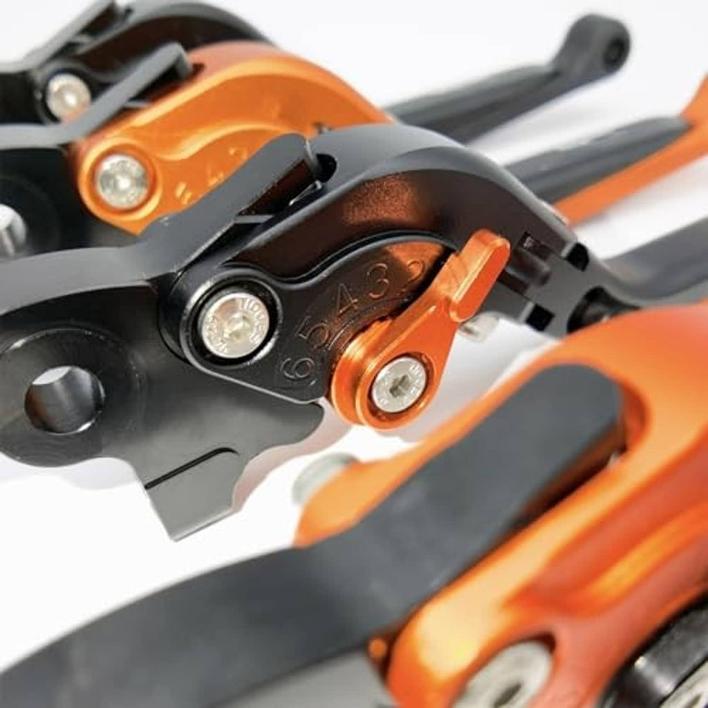 Close-up of orange and black motorcycle brake lever adjuster with screws and bolts