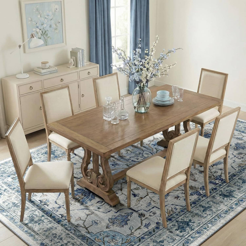 Blue/white/gray area rug with ornate border pattern under dining set
