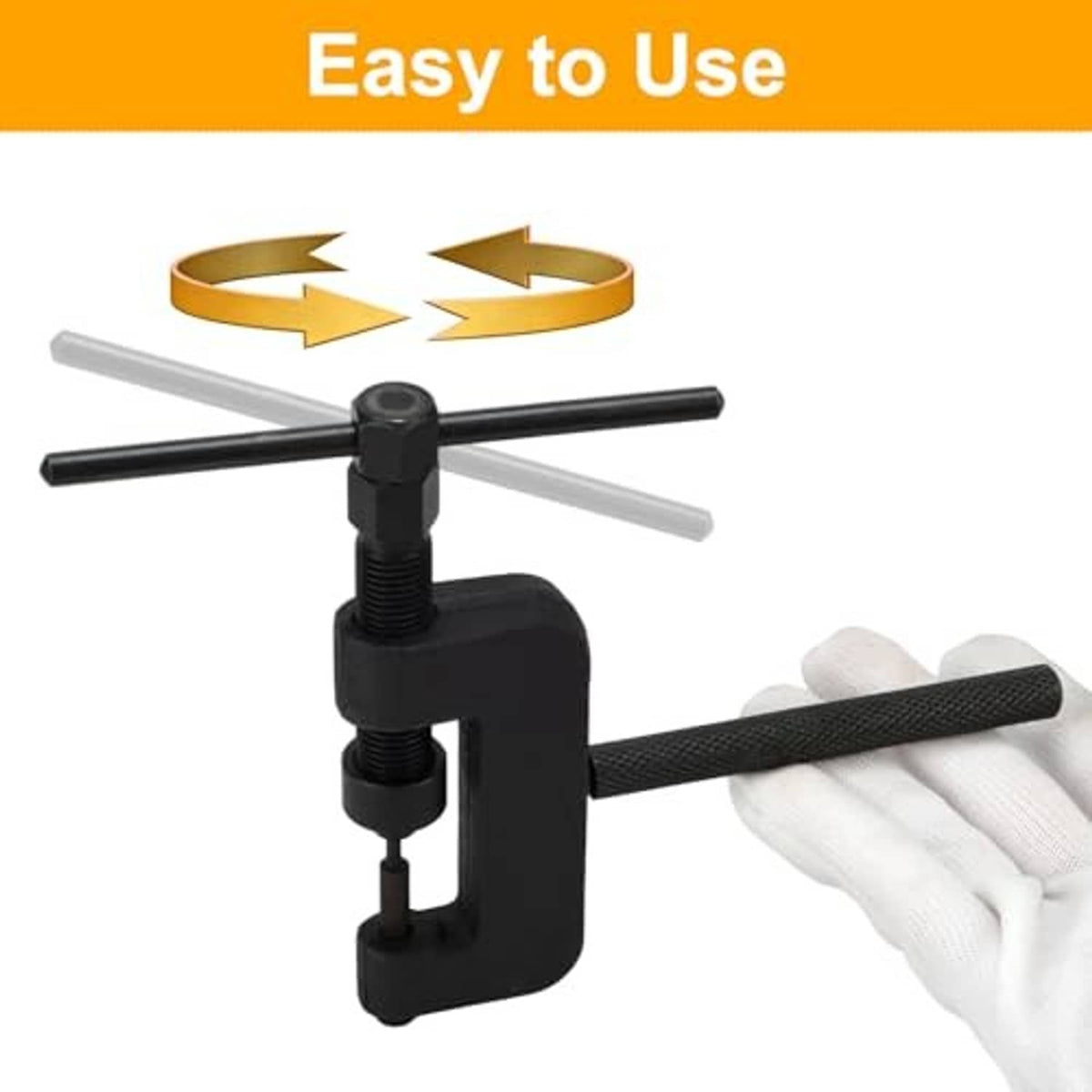 Motorcycle chain breaker tool with black press frame and cross handle, used with gloves