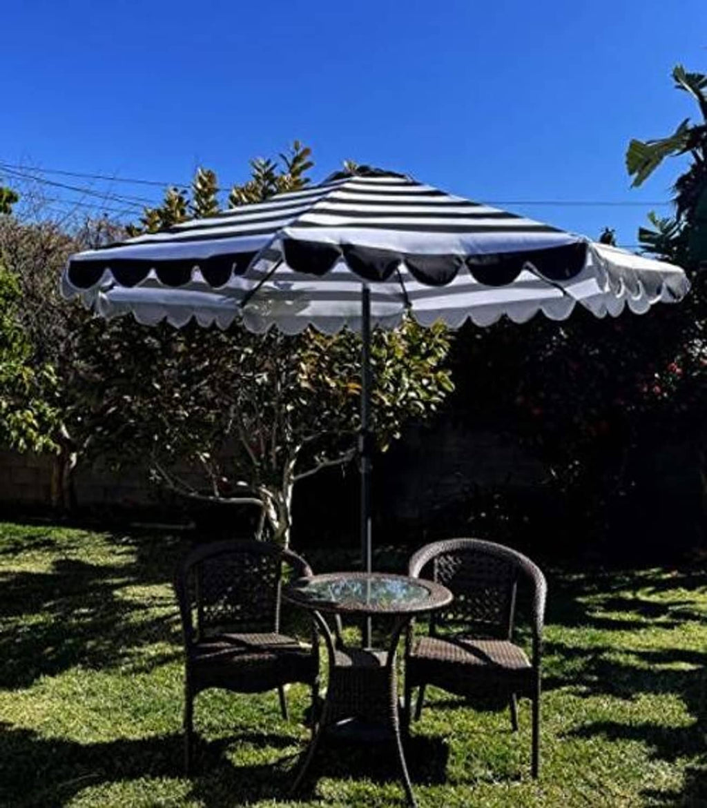 Black and white striped umbrella canopy with scalloped valance on patio umbrella