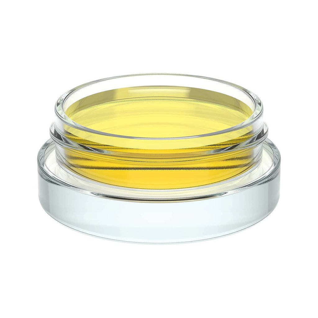 Clear glass jar with black lid and yellow gel inside