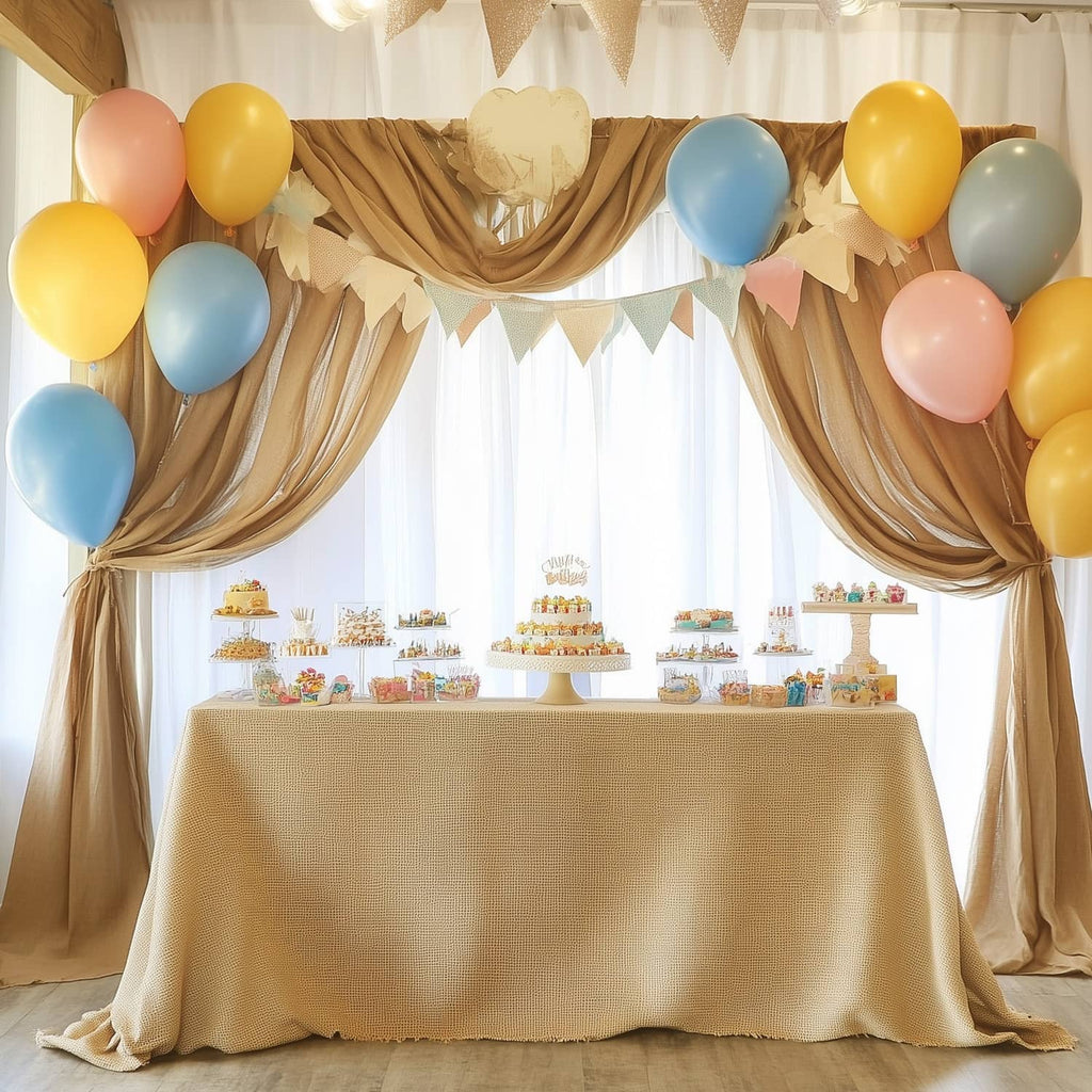 Natural burlap tablecloth and draped fabric backdrop with balloon party decorations