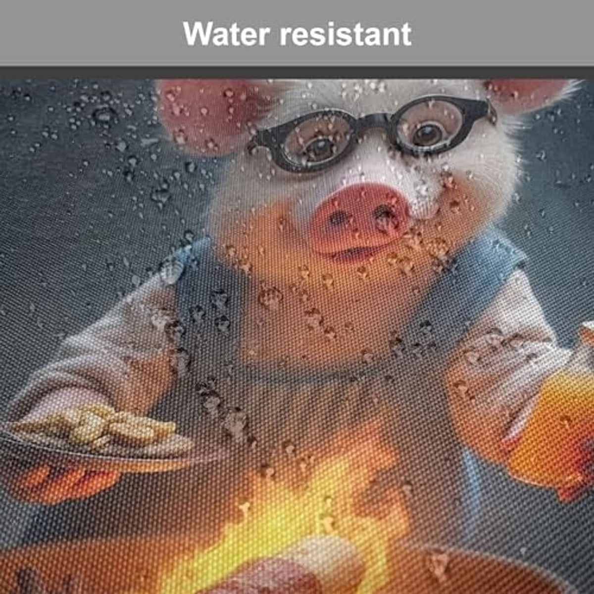 Water-resistant close-up of pig grilling print on dark blue apron with water droplets
