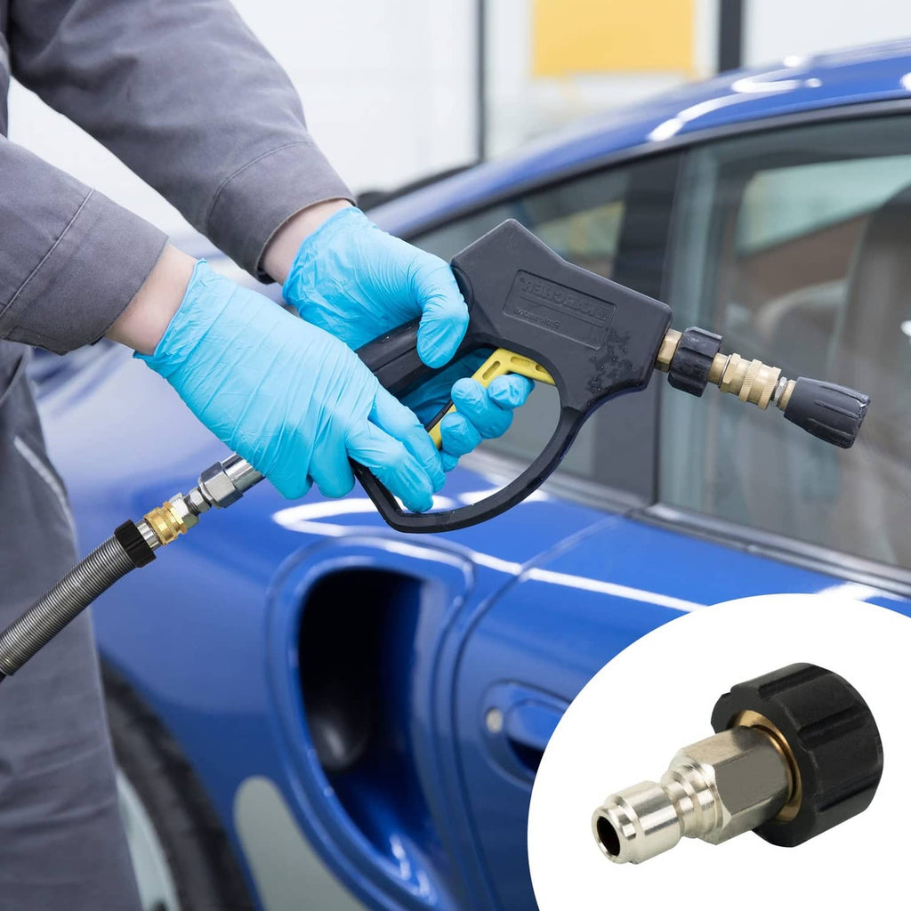 Brass quick-connect pressure washer fitting attached to hose with black grip and metal nozzle end
