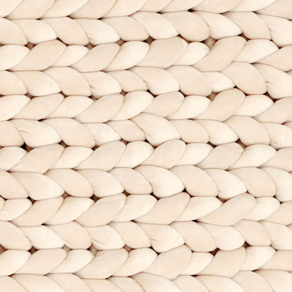 Beige chunky braided yarn strands in close-up texture.