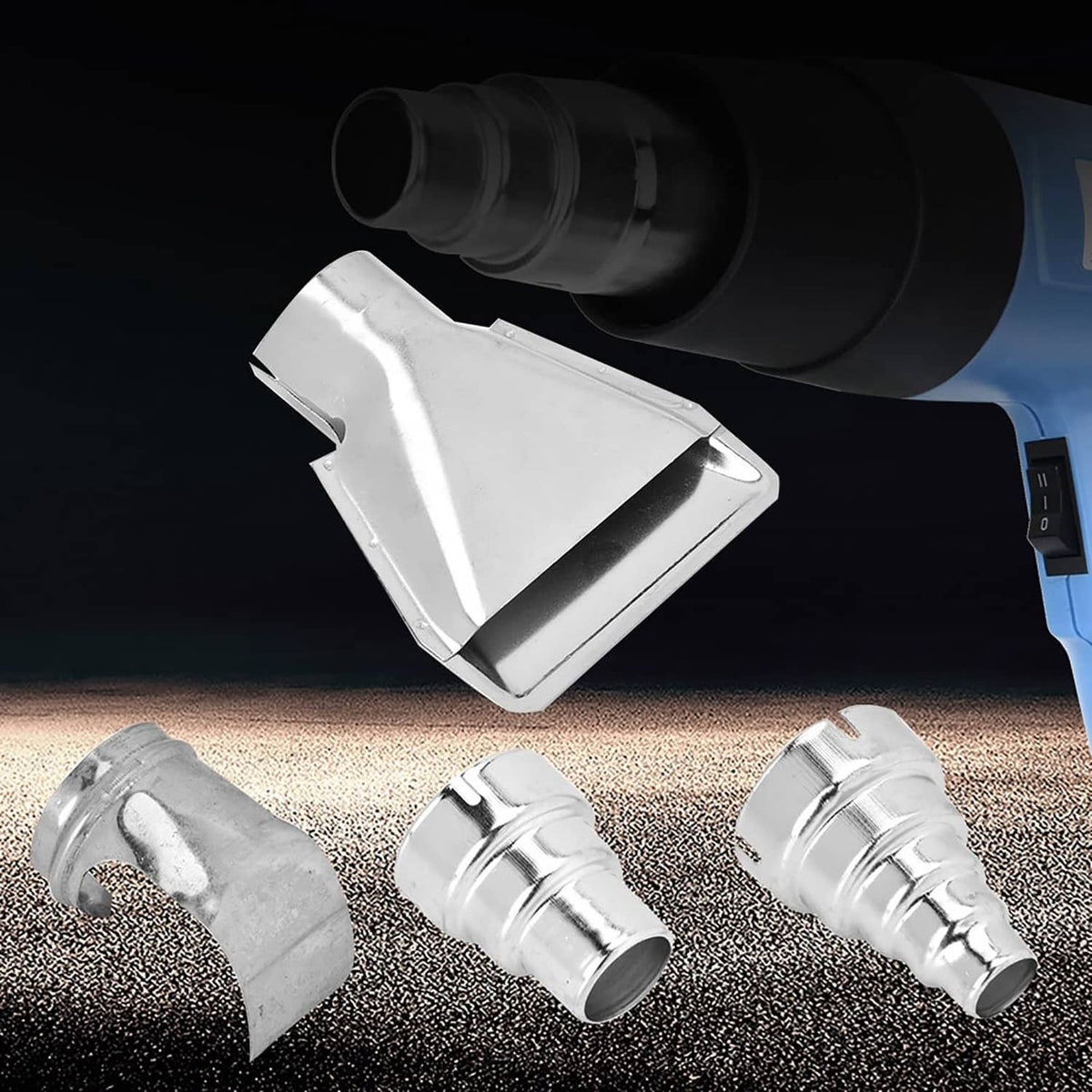 Heat gun nozzle attachments on gun tip: funnel nozzle, curved guide, and two cylindrical sleeves