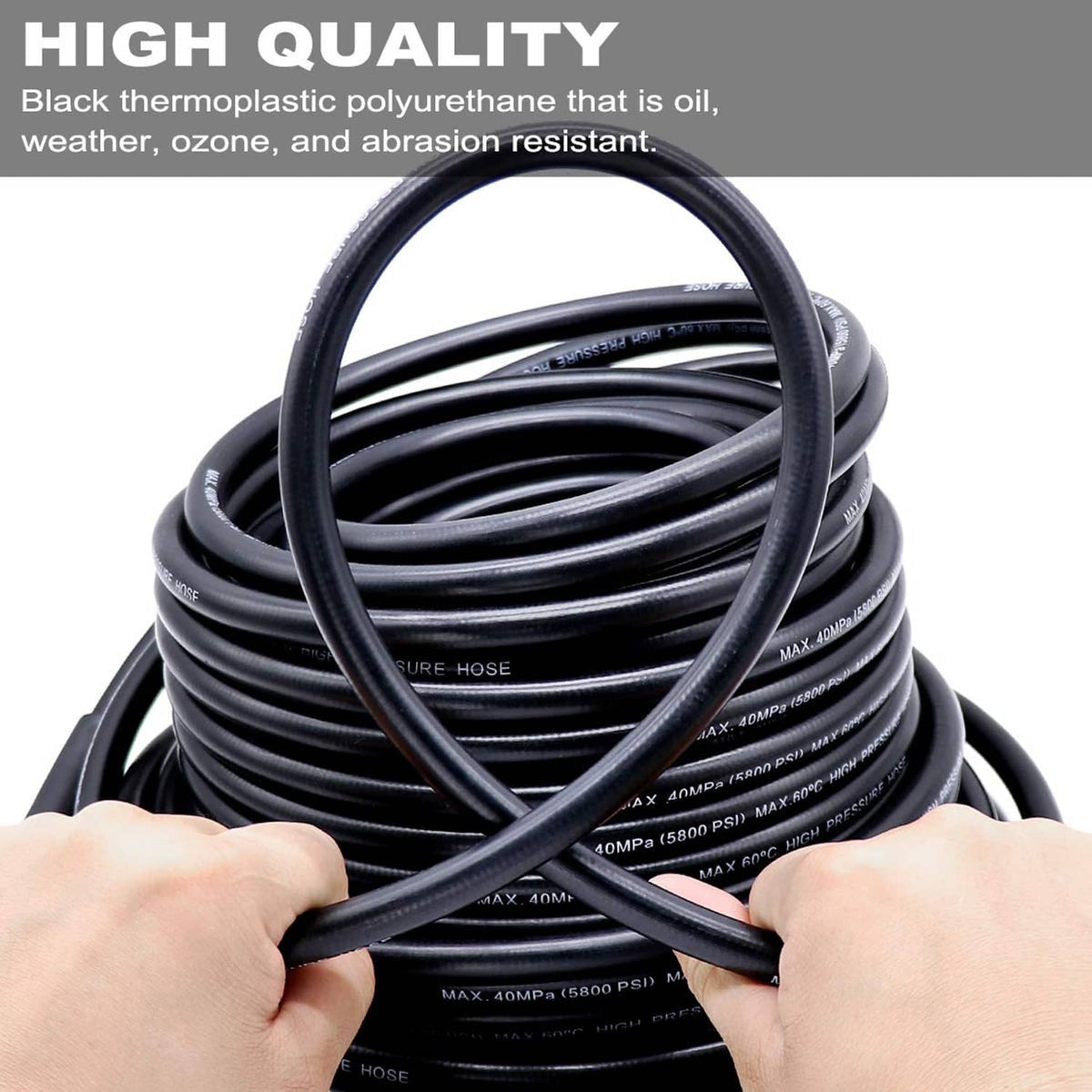 Coiled black sewer jetter hose with hands holding the hose loop for easy setup
