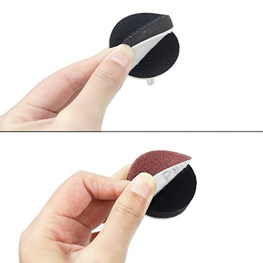 Handheld drill sanding disc on black backing pad with red abrasive top