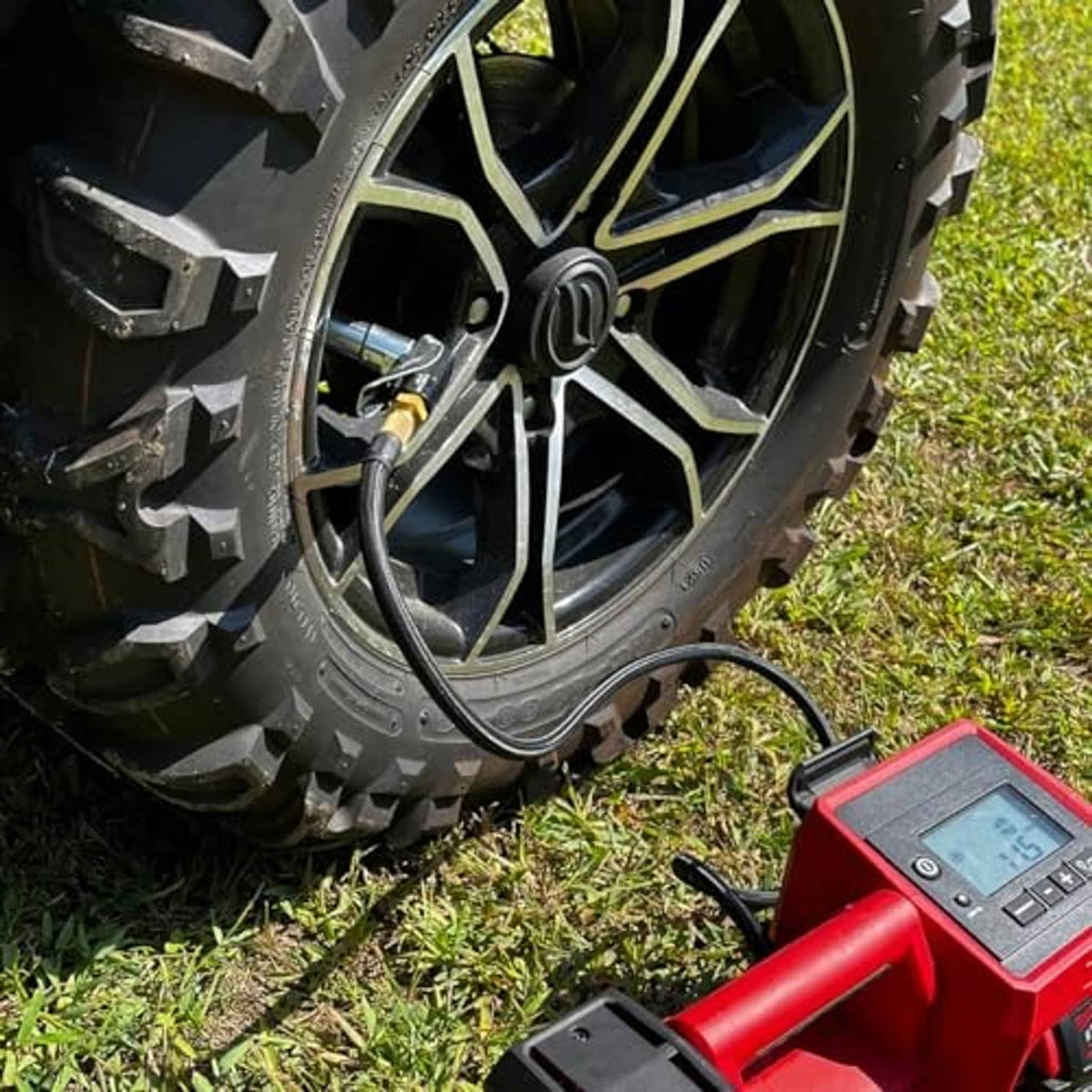90-degree air chuck connected to wheel valve, with hose leading to inflator