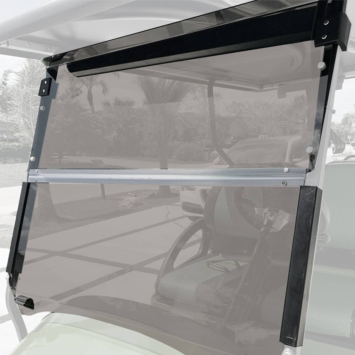 Fold-down tinted windshield with clear panel and black support frame on golf cart