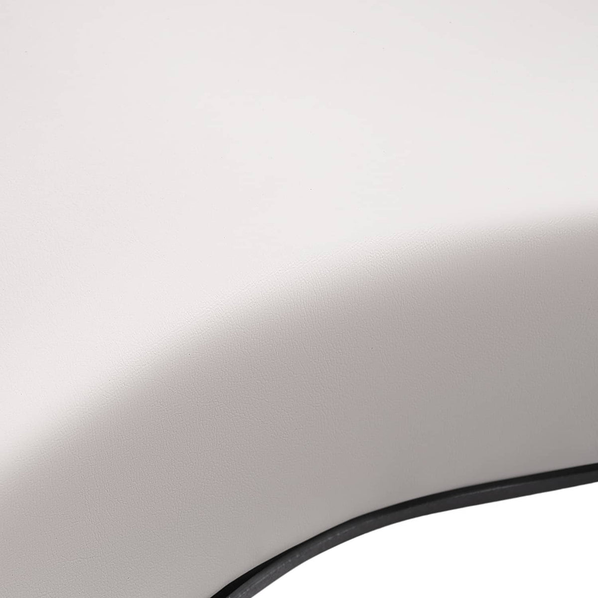 Close-up of white cushion material with visible black trim seam