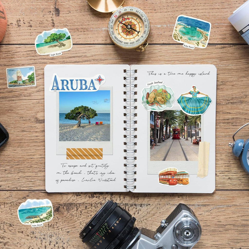 Aruba sticker set on an open notebook with beach and building design pieces