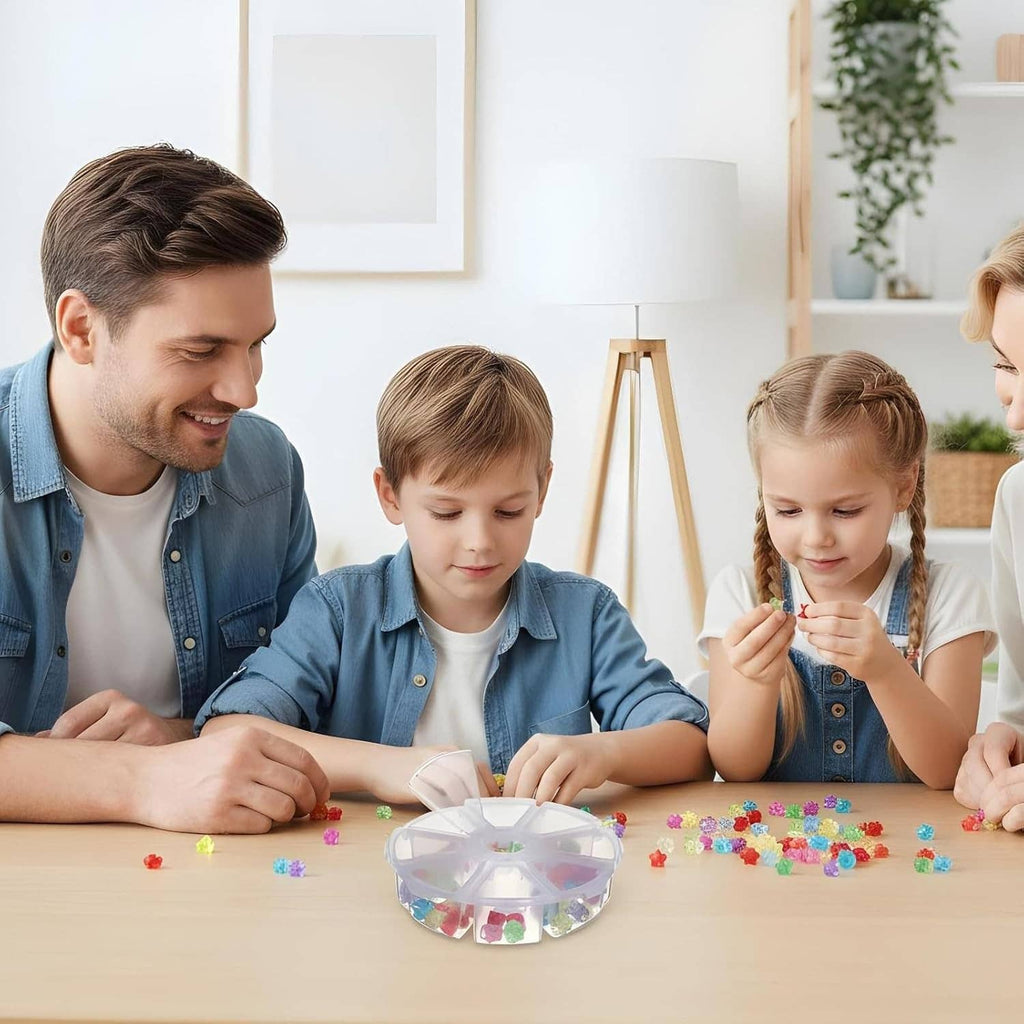 Clear round plastic bead organizer with 8 compartments on a craft table