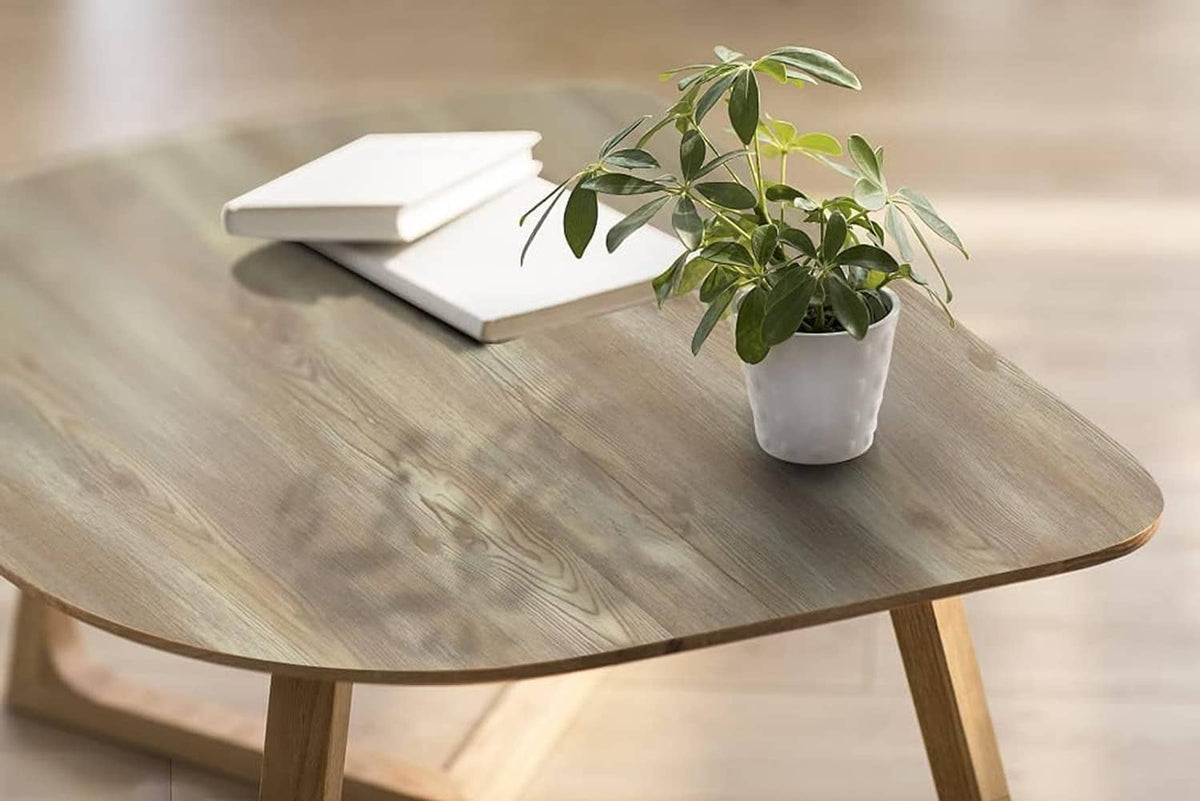 Wood-grain peel-and-stick paper covering a round table, light oak color