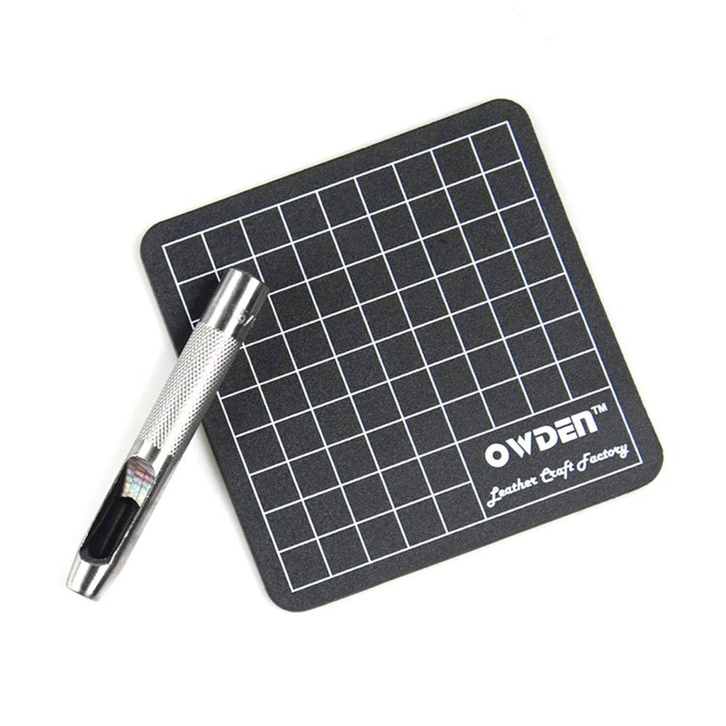 Black grid cutting mat with silver hollow punch tool