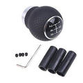 5-speed gear shift knob with black textured leather grip and metal shift-ring, numbered positions