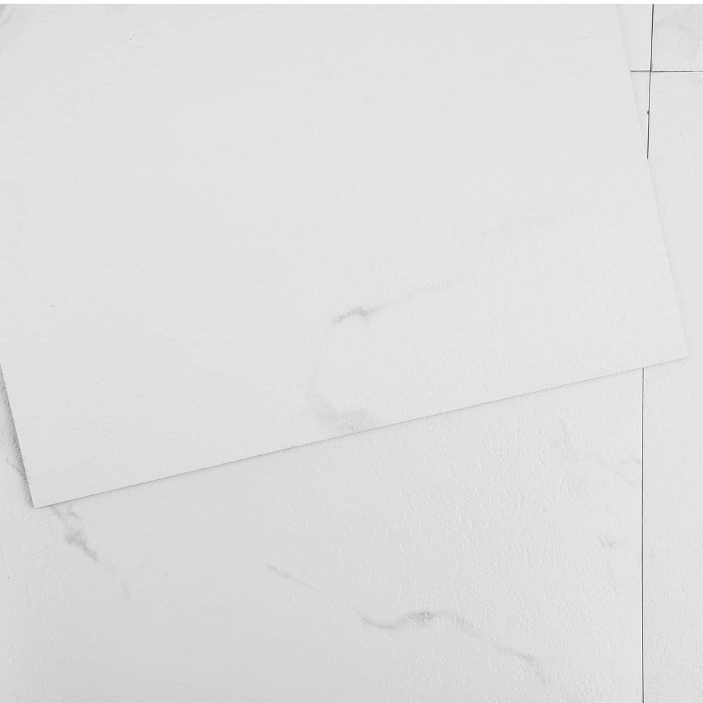 Close-up of white marble-pattern vinyl tiles with visible seams and veining
