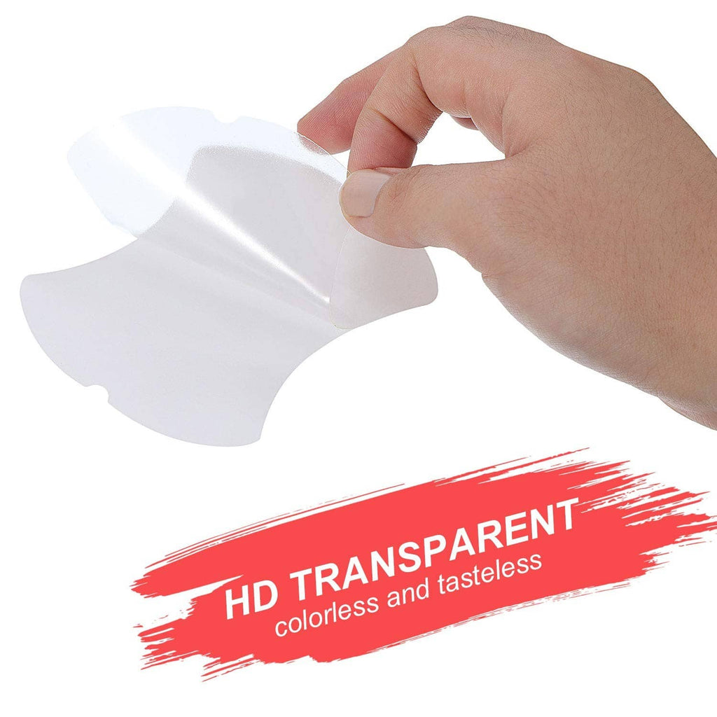 Hand placing a clear car door handle cup protector film over a door handle cup