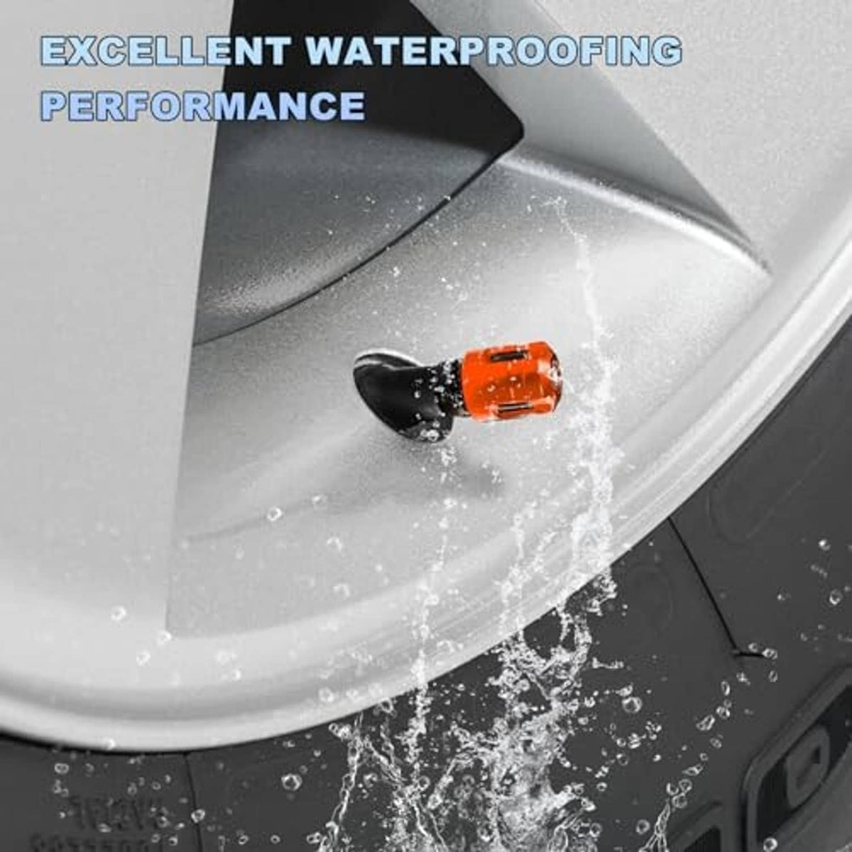 Orange tire valve stem cap near splashing water on a car wheel rim