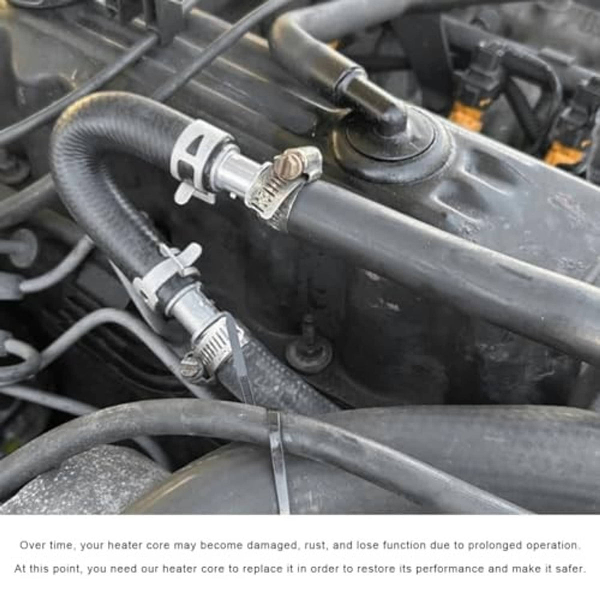 Installed engine heater bypass kit: black hose with silver fittings and metal clamp hardware