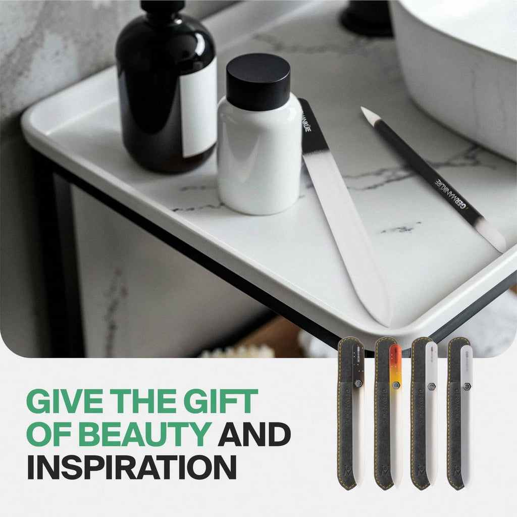 Assorted Germanikure glass nail files in suede sleeves on a bathroom tray