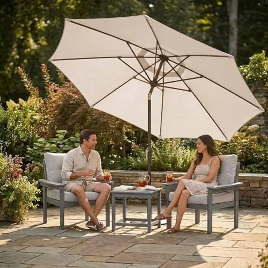 Beige patio market umbrella with open round canopy above outdoor dining seating