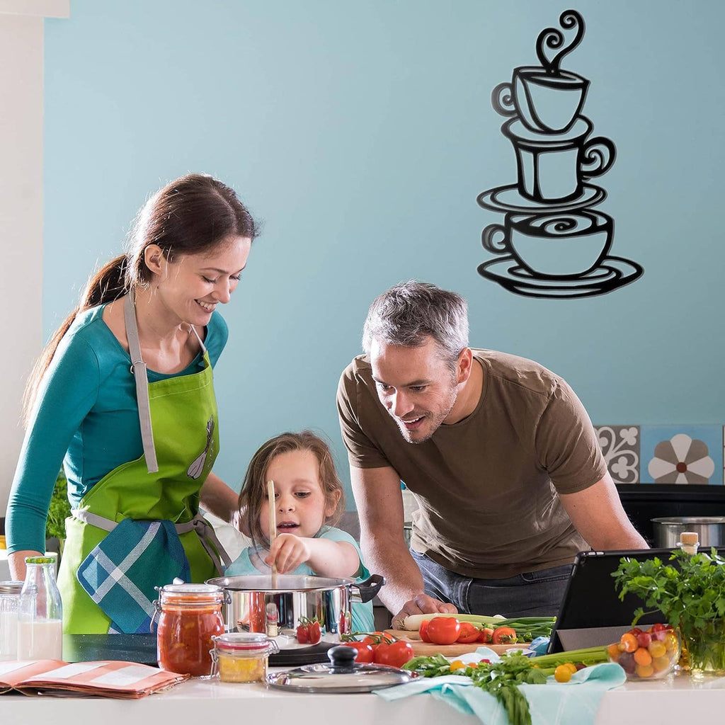 Dark metal coffee cup stack wall art above a family cooking scene