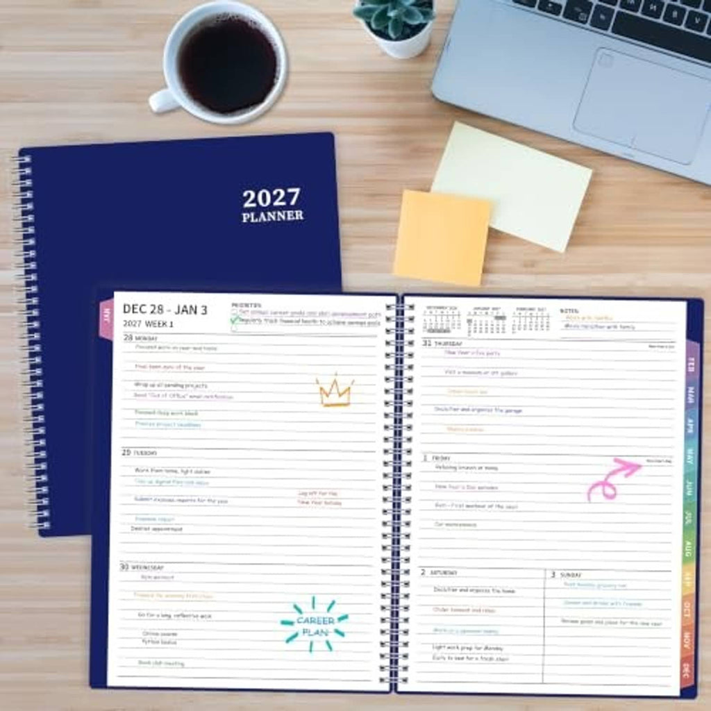 2027 planner open on a wooden desk with weekly pages visible beside sticky notes.